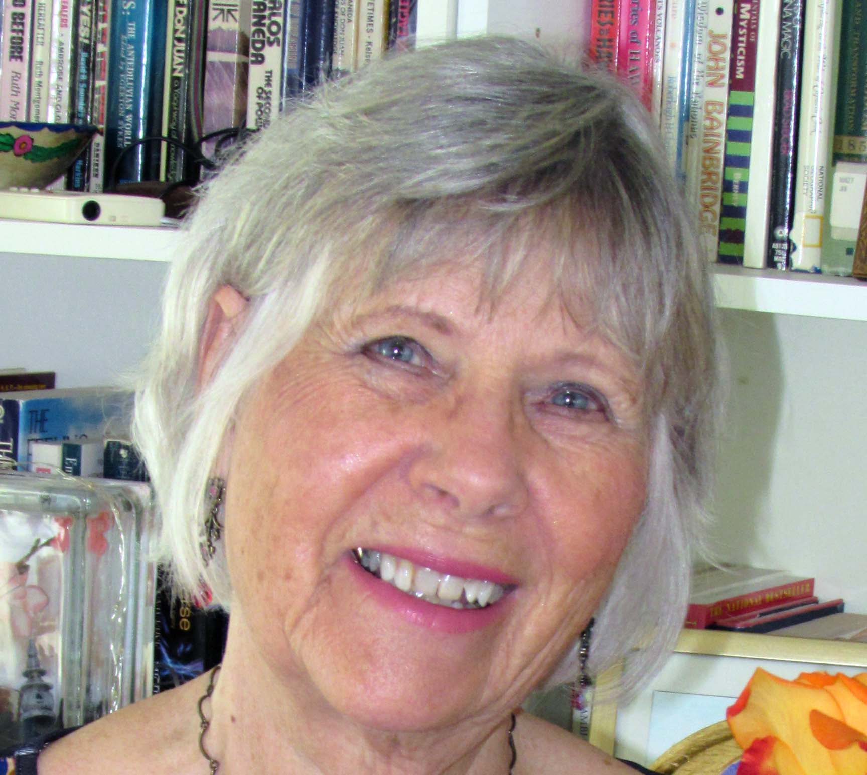 reverend doctor arlyn macdonald standing in front of a book shelf